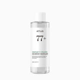A clear plastic bottle of Anua 77+ Heartleaf 77 + Hyaluron toner with a white cap and white label, shown against a light gray background.