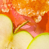 Close-up of a layered dessert with apples and orange jelly.