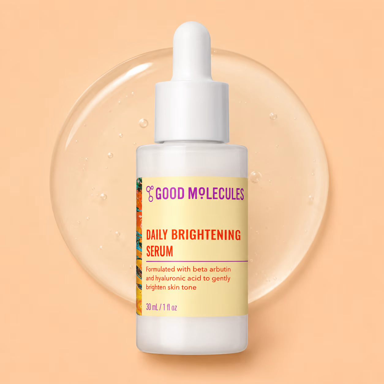 A bottle of Good Molecules Daily Brightening Serum with a white dropper cap and pale yellow label, centered against a peach background with a translucent circular gel bubble behind it.
