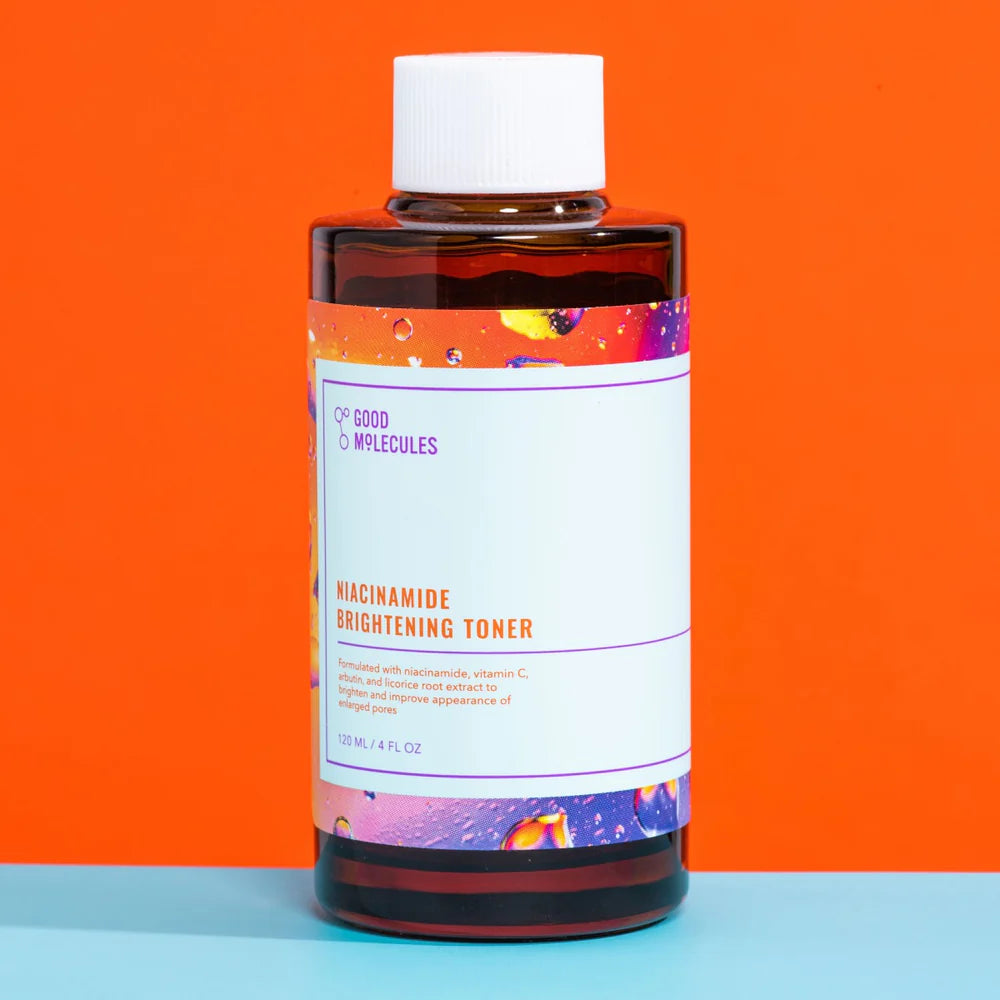 Bottle of Good molecules niacinamide brightening toner with colorful label on an orange and blue background